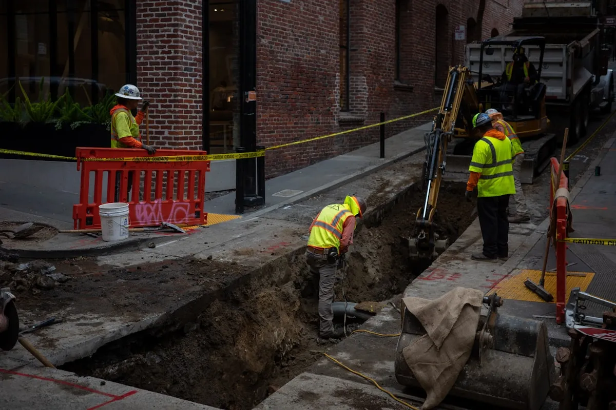 Underground construction workers digging a utility trench